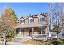 Two-story house with brick and siding, solar panels, and front porch at 12444 Knox Ct, Broomfield, CO 80020