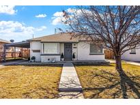 Charming single-story home featuring a well-maintained front yard, cozy entryway, and convenient carport at 3740 E Martin Luther King Jr Blvd, Denver, CO 80205