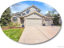 Charming two-story home with a well-manicured lawn and a spacious three car driveway at 10388 Lions Path, Lone Tree, CO 80124