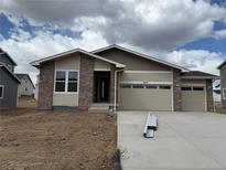 Charming single-Gathering home with a brick facade, two-car garage, and covered entry at 6975 E 126Th Dr, Thornton, CO 80602