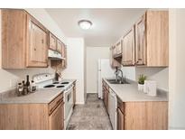 Functional kitchen with light wood cabinets, and standard appliances at 16259 W 10Th Ave # K1, Golden, CO 80401