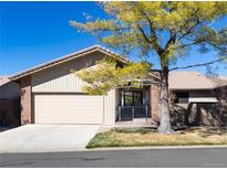 Charming single-story home featuring a two-car garage, mature tree, and a welcoming covered front porch at 2601 S Quebec St # 6, Denver, CO 80231