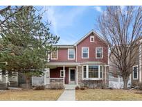 Charming two-story home with bay window and covered front porch, inviting curb appeal at 8335 Deframe Ct, Arvada, CO 80005