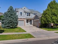 Charming two-story home with a well-manicured front lawn and spacious driveway at 11545 S Flower Mound Way, Parker, CO 80134