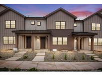Charming townhomes featuring board and batten siding and inviting covered front porches, great for enjoying peaceful evenings at 16774 W 93Rd Pl, Arvada, CO 80007