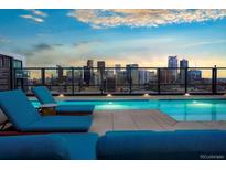 Rooftop pool featuring city views, lounge chairs, and a serene atmosphere, perfect for relaxation and enjoying the skyline at 1750 Wewatta St # 704, Denver, CO 80202