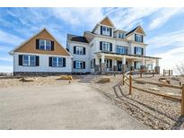 Impressive new construction home with meticulous landscaping, grand entrance, and a welcoming front porch at 10151 E 138Th Pl, Brighton, CO 80602