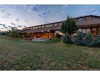 Expansive home exterior featuring an architectural design, large lawn, and inviting outdoor space at 6455 Dakota Ridge Dr, Golden, CO 80403