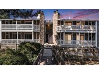 Inviting condo building with charming stone accents and private balconies at sunset at 18106 E Ohio Ave # 103, Aurora, CO 80017