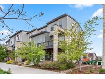 Beautifully landscaped modern townhome with stone accents, a balcony, and attractive curb appeal at 2521 Moline St, Aurora, CO 80010