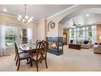 Bright living room with fireplace, large windows, and neutral decor for a cozy and inviting atmosphere at 15501 E 112Th Ave # 33D, Commerce City, CO 80022
