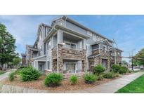 Beautiful townhome with stone accents and private balconies offers a charming and inviting exterior at 5255 Memphis St # 1009, Denver, CO 80239