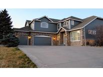 Beautiful two-story home featuring a three-car garage and stone accents at 9407 E 147Th Pl, Brighton, CO 80602