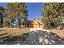 Charming home with mature trees, a wide driveway and an attached two car garage at 11 Strawflower Ln, Golden, CO 80401