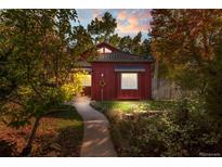 Charming red house with landscaping and walkway at 704 E Baseline Rd, Lafayette, CO 80026