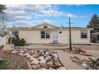 Charming home featuring a well-maintained exterior with inviting front yard landscaping at 1683 Monroe St, Strasburg, CO 80136