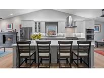 Modern kitchen with a large island, stainless steel appliances, and open floor plan at 2687 E 124Th Pl, Thornton, CO 80241
