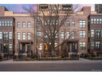 Attractive brick townhomes with well-manicured landscaping and secure black metal fencing at 1674 Fillmore St # Al3, Denver, CO 80206
