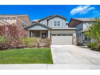 Charming two-story home with a well-manicured lawn, inviting curb appeal, and a two-car garage at 476 Hyde Park Cir, Castle Pines, CO 80108