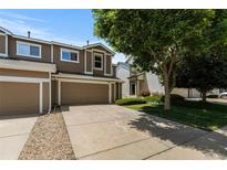 Charming townhome featuring a two-car garage, well-maintained landscaping, and inviting curb appeal at 2430 E 109Th Dr, Northglenn, CO 80233