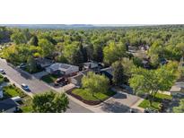 Breathtaking aerial view showcases the neighborhood's lush landscaping, mature trees, and charming homes at 10909 W 65Th Way, Arvada, CO 80004