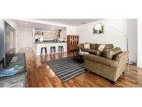Comfortable living room with open floor plan, breakfast bar, hardwood floors and stylish decor at 1560 Blake St # 810, Denver, CO 80202