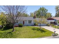 Charming ranch-style home with a well-manicured lawn, mature trees, and a cozy, inviting atmosphere at 1322 Wicklow St, Boulder, CO 80303
