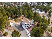 Home with attached garage in wooded setting at 9189 Fallen Rock Rd, Conifer, CO 80433