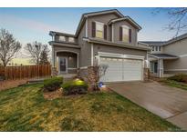 Charming two-story home featuring a well-manicured lawn and attached two-car garage at 5171 E 119Th Ct, Thornton, CO 80233