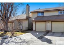 Charming exterior view of townhome with attached garage, neutral color, and well-maintained landscape at 4203 Owens St, Wheat Ridge, CO 80033