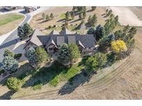 Expansive property featuring a luxurious home nestled amongst mature trees and a horse pasture at 9250 Steeplechase Dr, Franktown, CO 80116