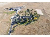 Expansive property featuring a well-maintained home, horse facilities, riding arena, and landscaped grounds at 9250 Steeplechase Dr, Franktown, CO 80116