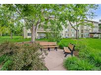 Inviting community benches sit under mature trees, enhancing the building's serene and park-like setting at 755 S Alton Way # 9D, Denver, CO 80247