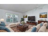 Bright living room with stylish furniture, a large TV, and a sliding glass door to a balcony at 755 S Alton Way # 9D, Denver, CO 80247