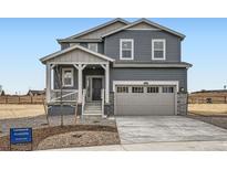 Charming two-story home with a welcoming porch, attached two-car garage, and professionally landscaped front yard at 11052 Snowdon St, Parker, CO 80134