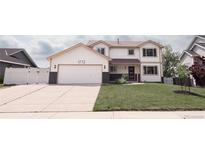Charming two-story home with a well-manicured lawn, two car garage, and inviting curb appeal at 1772 Eisenhower, Louisville, CO 80027