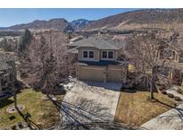 A lovely home with a spacious driveway, a two-car garage, and a well-manicured lawn at 8493 S Newcombe Way, Littleton, CO 80127