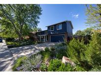 Charming two-story home with a well-manicured front yard and a spacious driveway in a desirable neighborhood at 1424 Cypress Cir, Lafayette, CO 80026