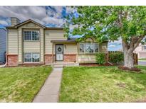 Charming home features a well-manicured lawn and lovely landscaping at 4302 Nepal St, Denver, CO 80249