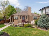 Charming home features a manicured lawn, front porch, a pergola and beautiful landscaping at 4425 Irving St, Denver, CO 80211