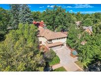 Luxury home with spacious driveway, surrounded by lush trees at 5635 E 17Th Avenue Pkwy, Denver, CO 80220