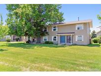 Charming townhome with a well-manicured lawn and a large shade tree in a quiet neighborhood at 1927 S Peoria St, Aurora, CO 80014