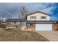 Charming two-story home featuring a brick facade, updated windows, solar panels, and a well-manicured front yard at 8813 W Arbor Ave, Littleton, CO 80123