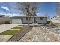 Charming single-story home with a well-manicured front yard and a cozy, inviting entrance at 6083 S Dudley Way, Littleton, CO 80123