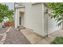Two story home with vinyl siding, walkway, and attached two car garage at 5522 S Quemoy Cir, Aurora, CO 80015