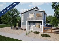 Charming two-story home featuring gray siding, a quaint balcony, and a well-maintained stone yard at 46558 Avery Ln, Bennett, CO 80102