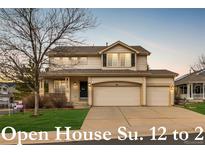 Charming two-story home featuring a three-car garage and covered porch at 7661 Chickaree Ct, Littleton, CO 80125