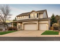 Charming two-story home with a two-car garage and a beautifully maintained lawn at 7661 Chickaree Ct, Littleton, CO 80125
