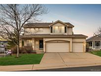 Inviting two-story home featuring a covered porch and a spacious three-car garage at 7661 Chickaree Ct, Littleton, CO 80125