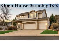 Charming two-story home with a well-maintained lawn and three-car garage at 7661 Chickaree Ct, Littleton, CO 80125